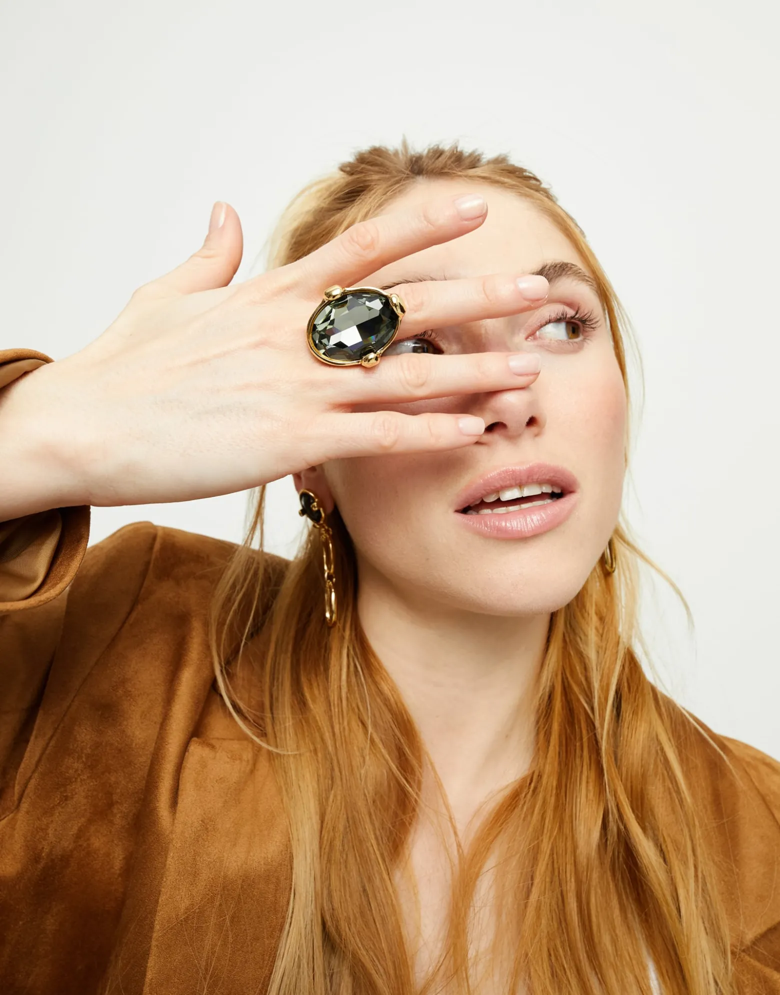 Large ring with oval faceted gray crystal