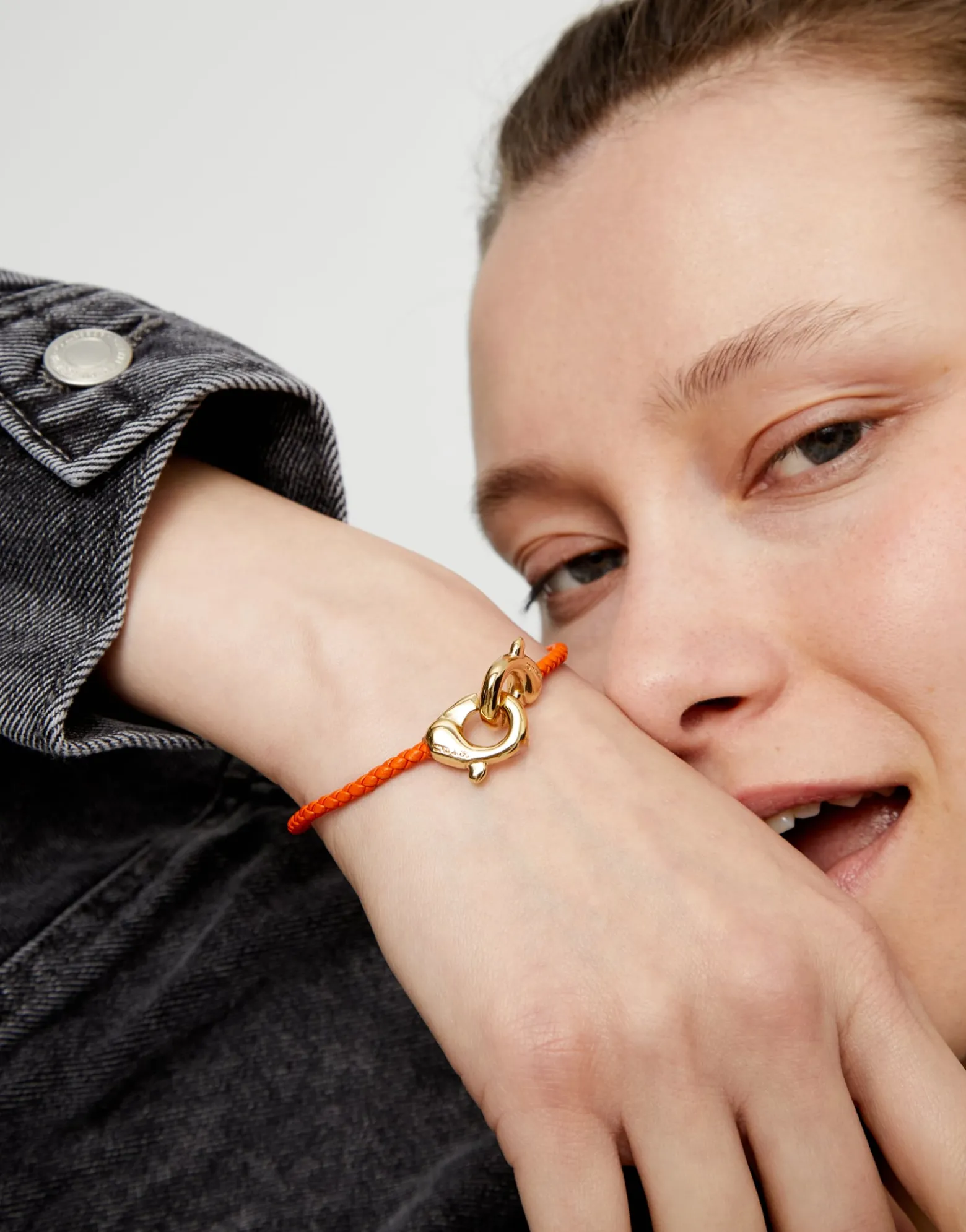 Orange leather bracelet with interlocking carabiner